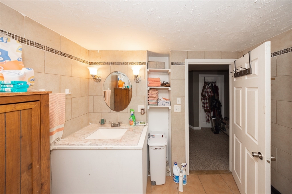 151 Mechanic Street Fitchburg, MA 01420 - Photo 23 of 42 a bathroom with a sink and a mirror