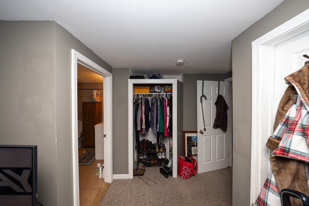 151 Mechanic Street Fitchburg, MA 01420 - Photo 25 of 42 a view of walk in closet with clothes and shoes