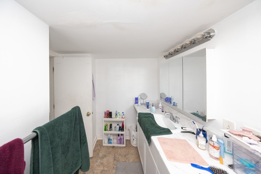 151 Mechanic Street Fitchburg, MA 01420 - Photo 27 of 42 a bathroom with a tub sink and mirror