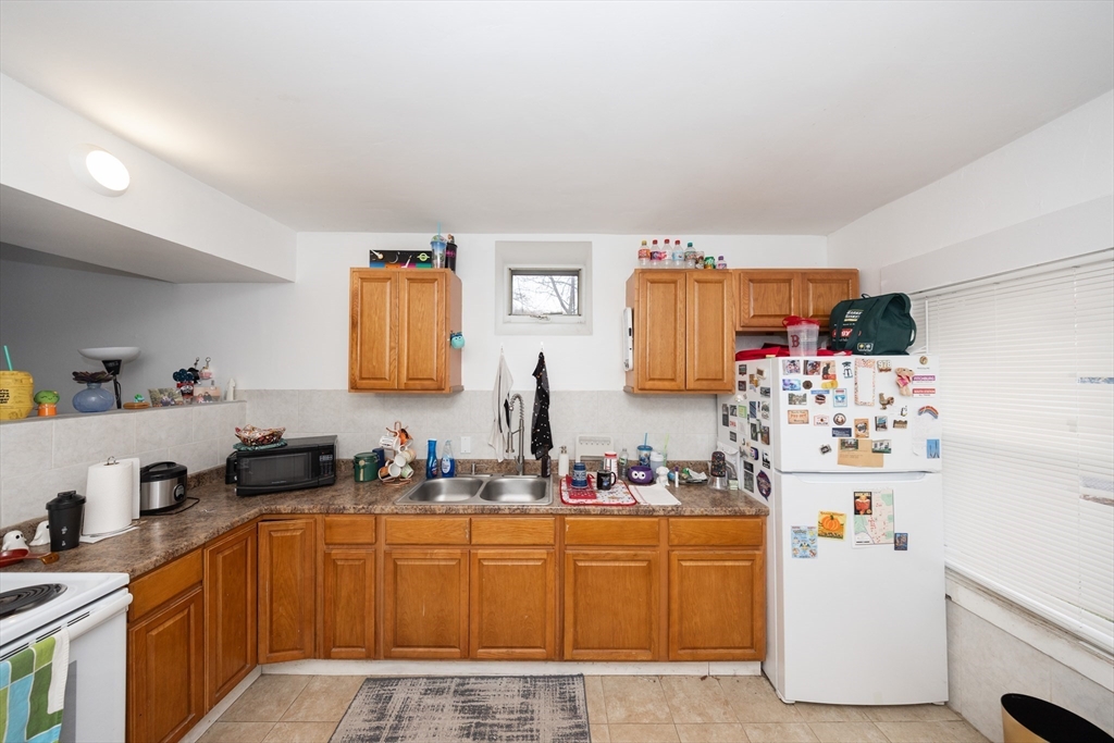151 Mechanic Street Fitchburg, MA 01420 - Photo 33 of 42 a kitchen with a refrigerator and a sink