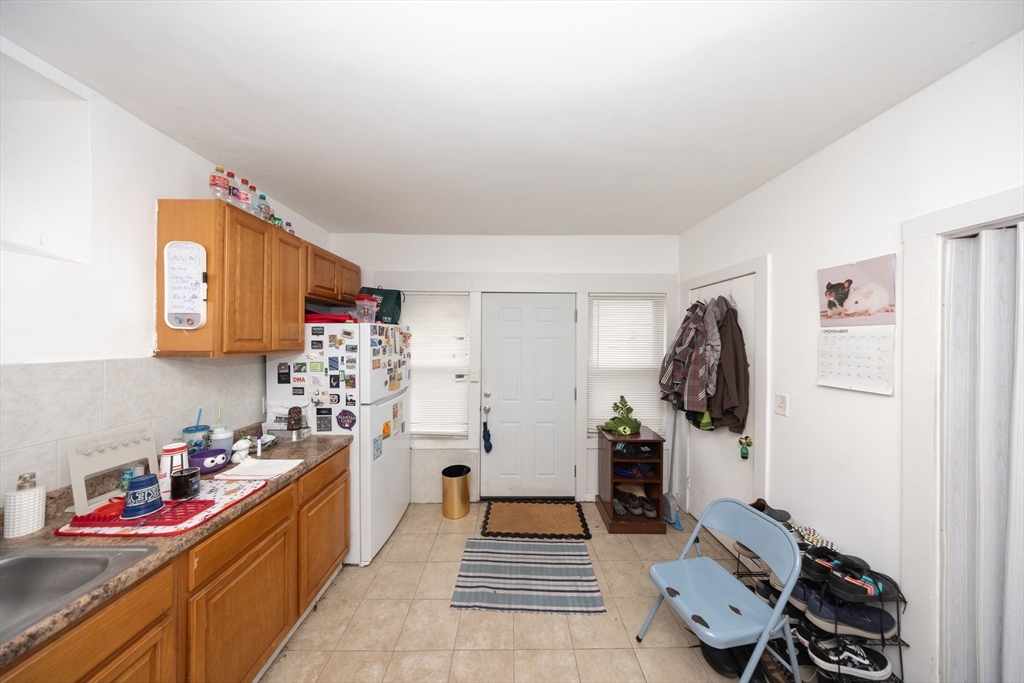 151 Mechanic Street Fitchburg, MA 01420 - Photo 34 of 42 a kitchen with a refrigerator and a stove top oven