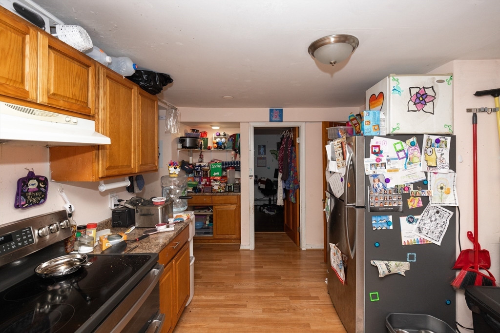 151 Mechanic Street Fitchburg, MA 01420 - Photo 5 of 42 a kitchen with stainless steel appliances granite countertop a refrigerator and stove