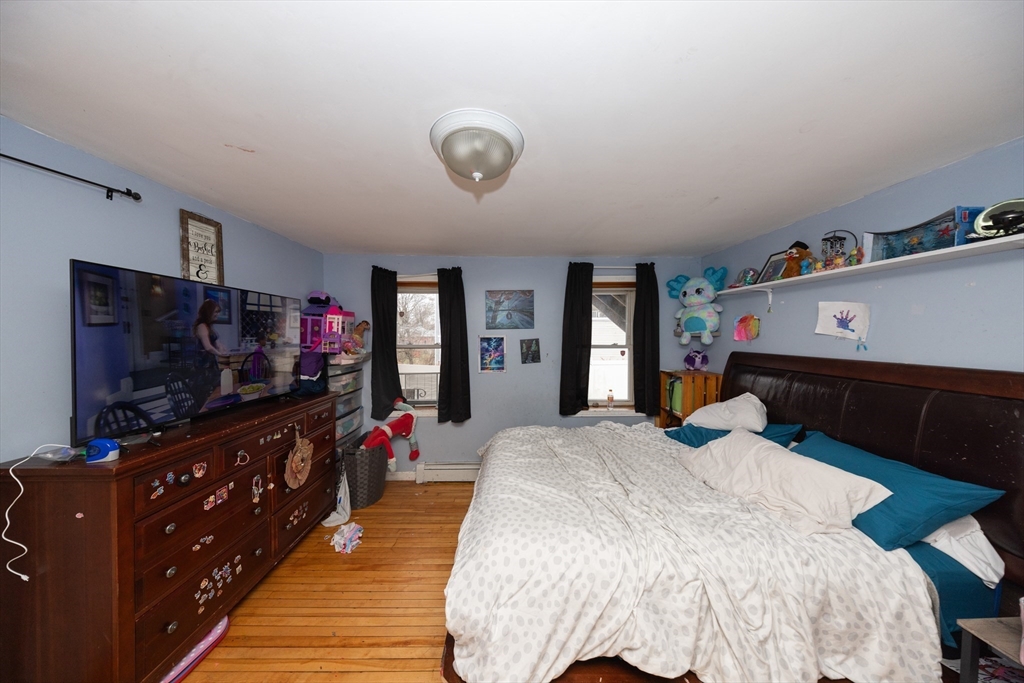 151 Mechanic Street Fitchburg, MA 01420 - Photo 7 of 42 a bed room with a bed and a flat screen tv