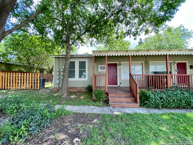 a front view of a house with garden and patio
