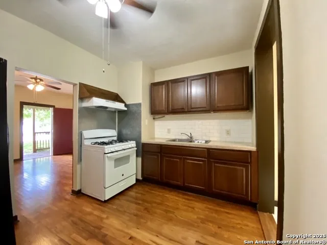 a kitchen with stainless steel appliances granite countertop a sink and stove top oven