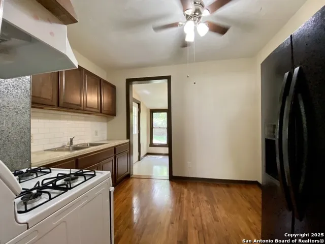 a kitchen with a stove and a refrigerator