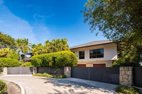 a living room with furniture a flat screen tv and floor to ceiling window