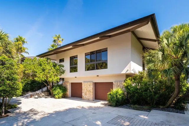 a large white kitchen with a large window