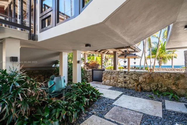 a view of a dining room with furniture large window and chandelier
