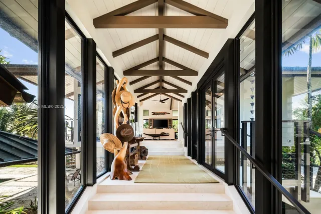 a living room with furniture and a floor to ceiling window