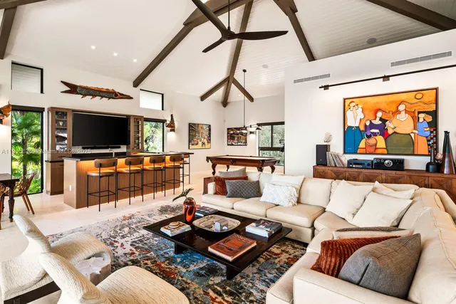 a kitchen that has a sink and a view of living room