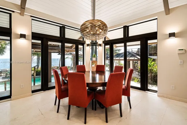 a large kitchen with stainless steel appliances kitchen island a large counter top a stove and a refrigerator