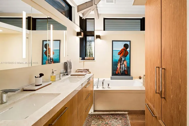 a white house with a large pool lawn chairs and palm tree