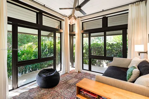 a front view of a building with garden and swimming pool