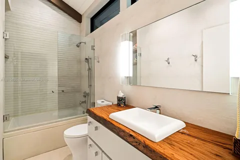 a front view of a house with garden and trees