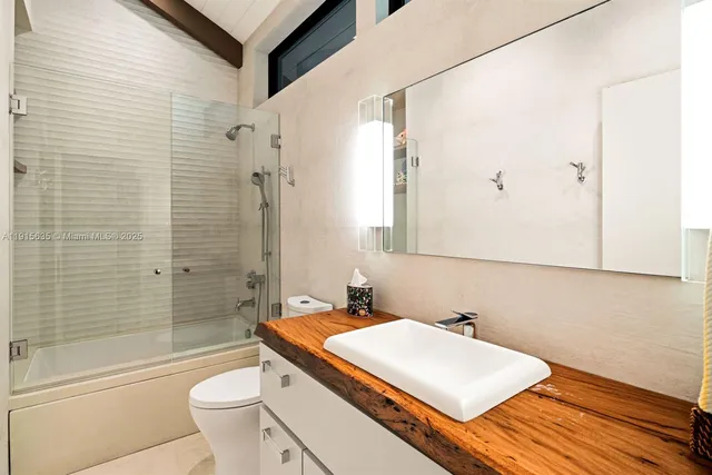 a front view of a house with garden and trees