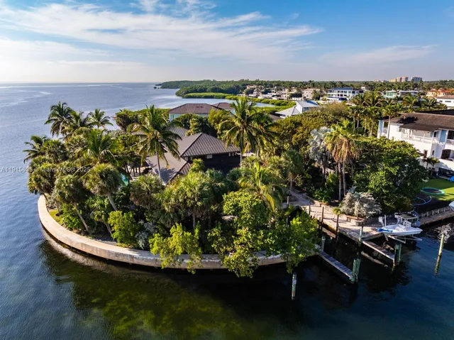 a house with lots of trees in the background