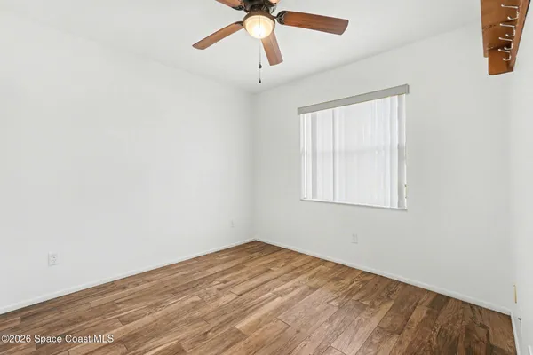 a view of a big room with wooden floor and windows in a room