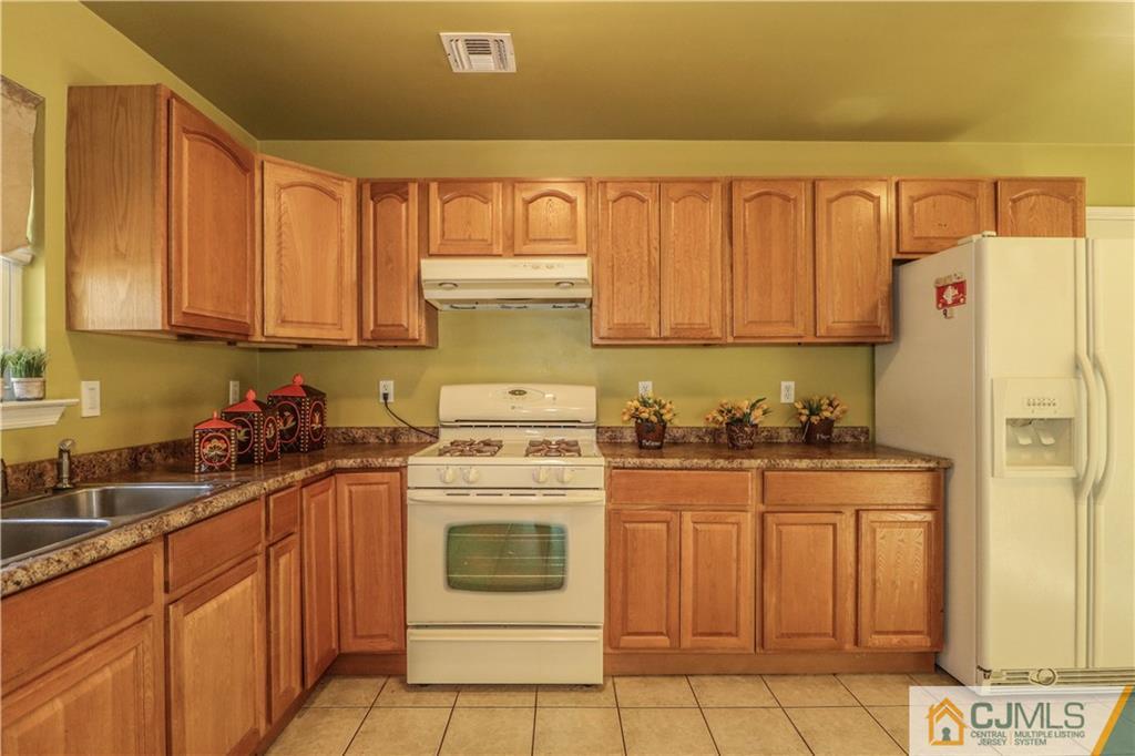 2 Altamont Road Edison, NJ 08817 - Photo 17 of 40 a kitchen with stainless steel appliances granite countertop a stove a sink and a refrigerator
