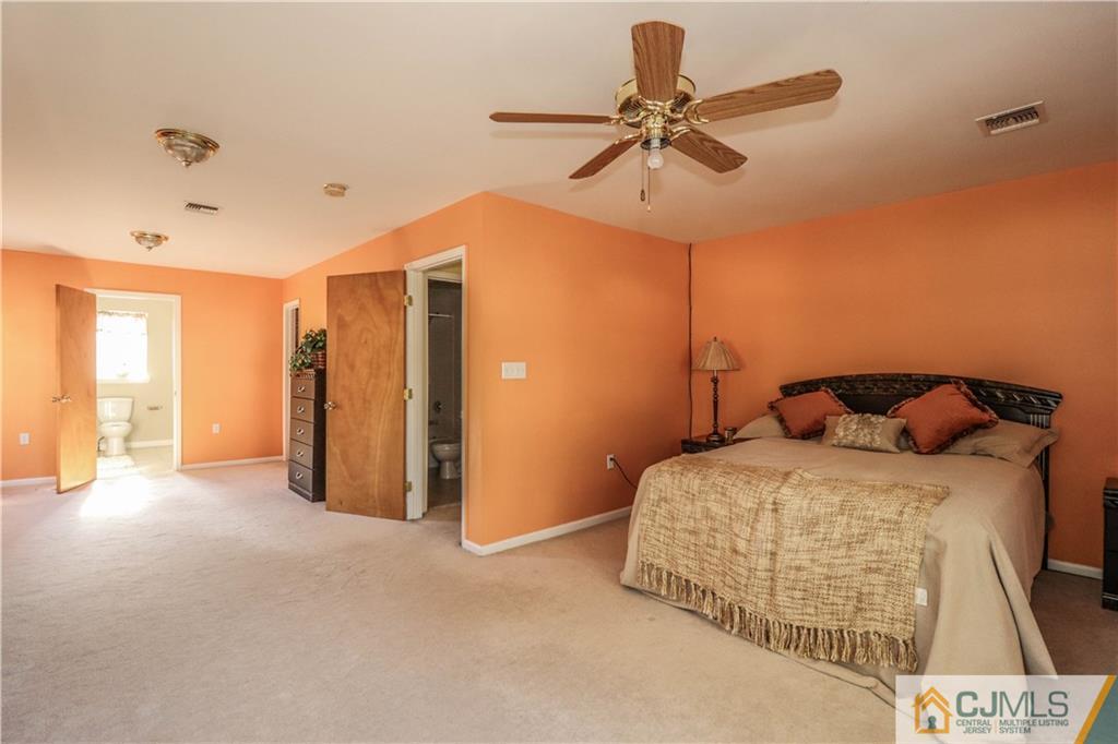 2 Altamont Road Edison, NJ 08817 - Photo 21 of 40 a bedroom with a bed and a chandelier
