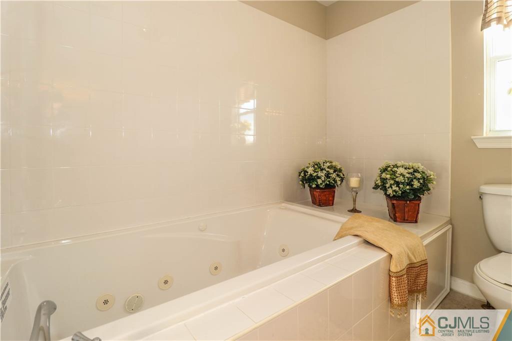 2 Altamont Road Edison, NJ 08817 - Photo 27 of 40 a bath tub sitting next to a white toilet and a sink