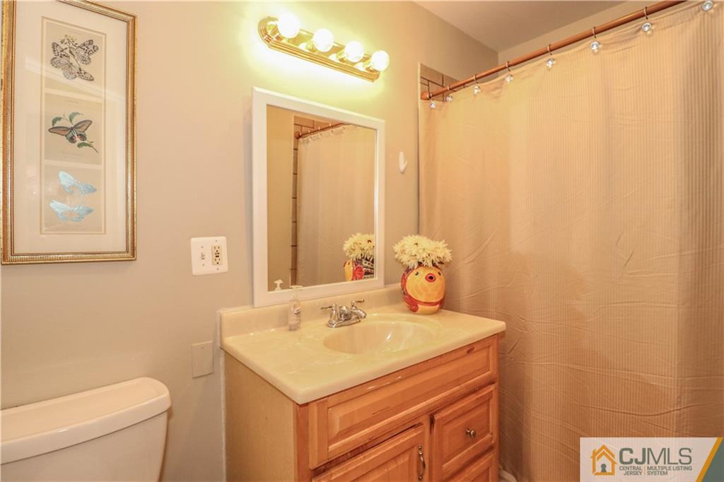 2 Altamont Road Edison, NJ 08817 - Photo 30 of 40 a bathroom with a sink a toilet and a mirror