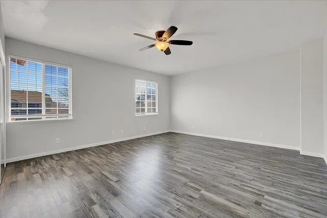 a view of empty room with wooden floor