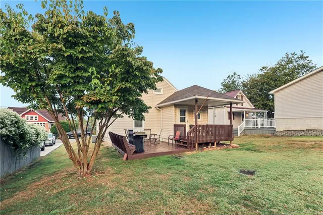 a view of a house with backyard and sitting area
