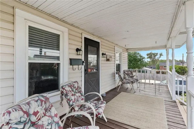 a balcony view with a large window and dining table