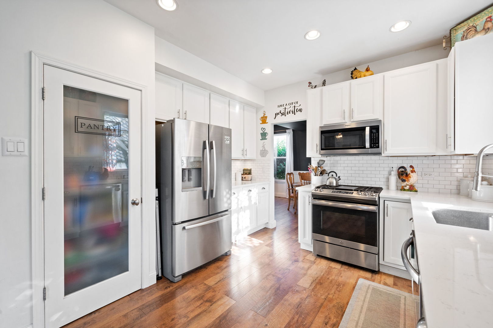 3409 Mustang Road Joliet, IL 60435 - Photo 8 of 28 a kitchen with stainless steel appliances a refrigerator sink and microwave