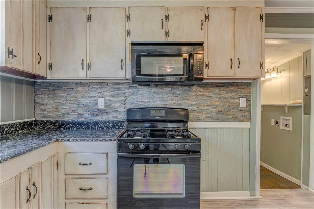 33 Elm Street Aragon, GA 30104 - Photo 12 of 34 a kitchen with granite countertop white cabinets stainless steel appliances and a counter space