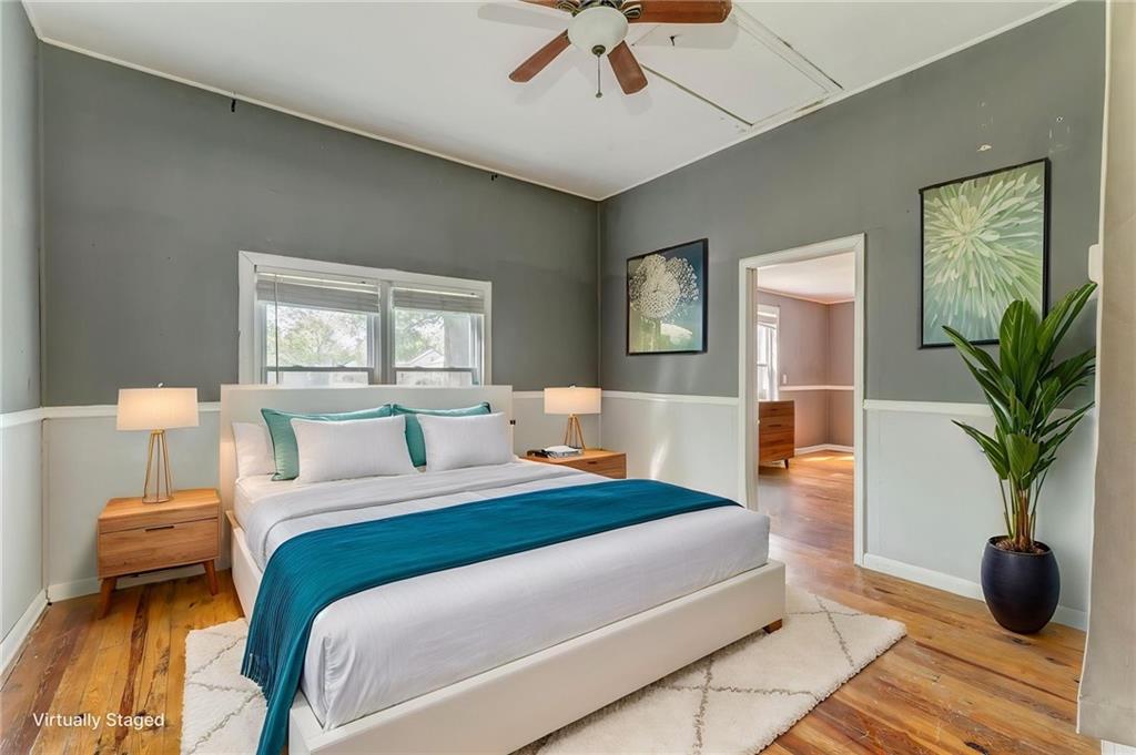 33 Elm Street Aragon, GA 30104 - Photo 18 of 34 a bedroom with a large bed and a potted plant