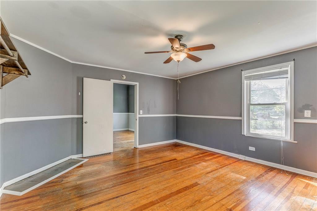 33 Elm Street Aragon, GA 30104 - Photo 23 of 34 a view of empty room with wooden floor and fan