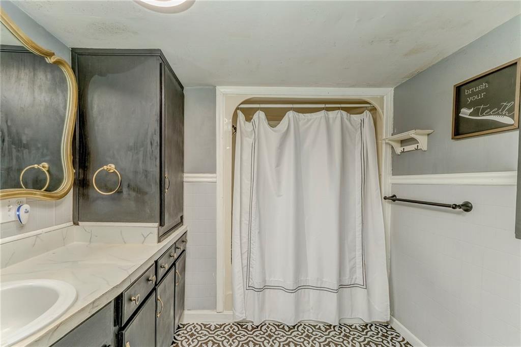 33 Elm Street Aragon, GA 30104 - Photo 30 of 34 a bathroom with a sink and mirror with shower