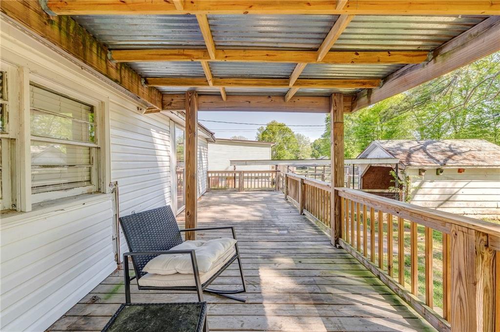 33 Elm Street Aragon, GA 30104 - Photo 34 of 34 a view of a porch with wooden furniture in front of it