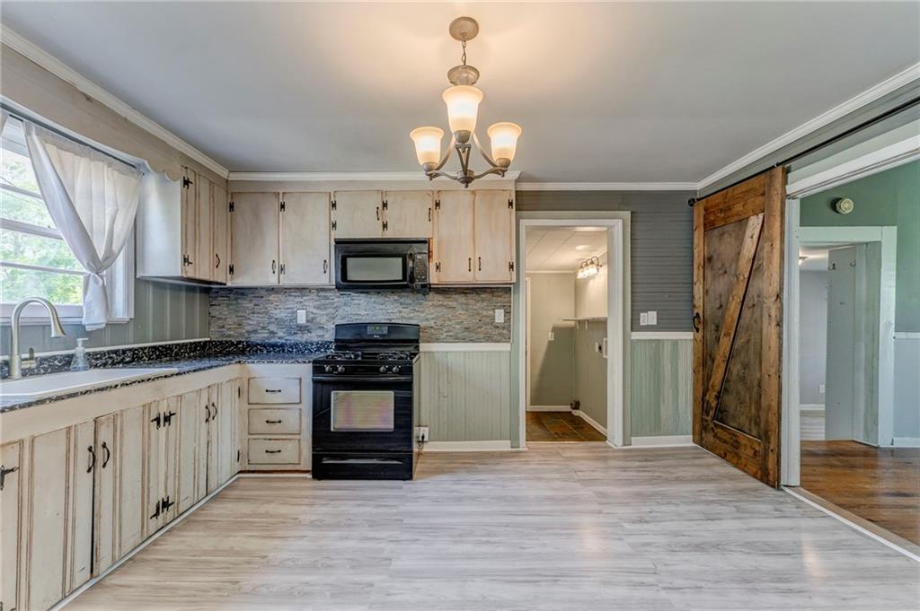 33 Elm Street Aragon, GA 30104 - Photo 10 of 34 a kitchen with stainless steel appliances granite countertop a refrigerator a sink dishwasher a stove and white cabinets with wooden floor