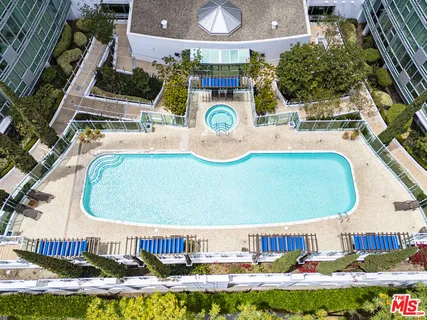 a view of a swimming pool with outdoor seating