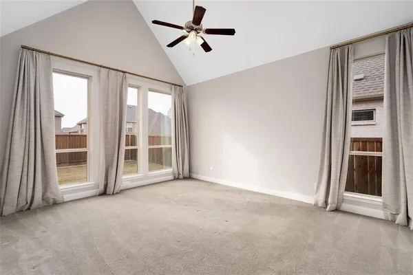 a large room with kitchen view and a chandelier