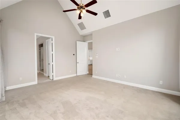 a kitchen with stainless steel appliances kitchen island granite countertop a refrigerator and a wooden floor