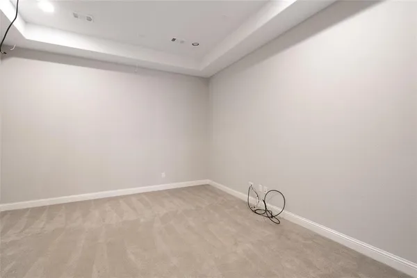 a view of an empty room and wooden floor