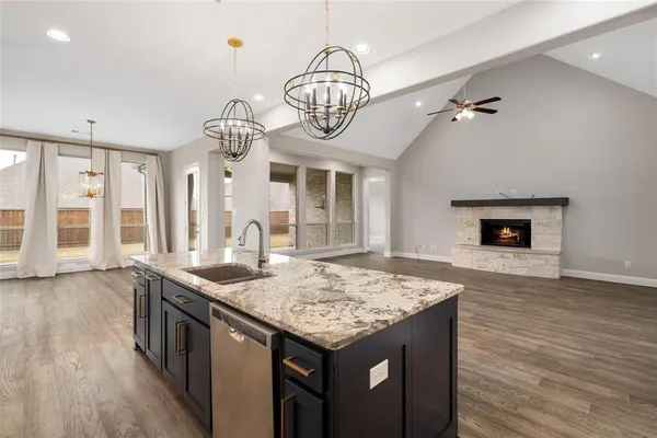 a view of an empty room with a fireplace and a large window