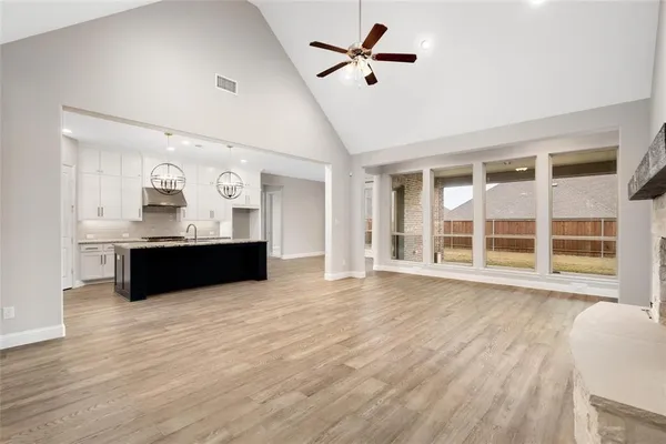 a kitchen with stainless steel appliances granite countertop a sink stove and wooden floor