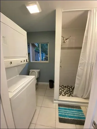 a bathroom with a sink a toilet and a shower
