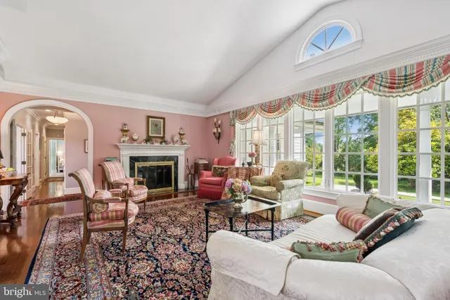 a living room with furniture a large window and a fireplace