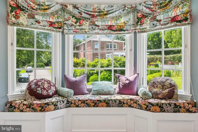 a living room filled with furniture and a large window