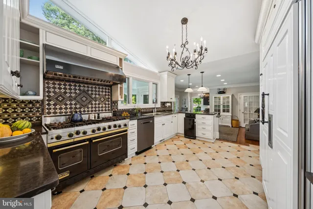 a kitchen with stainless steel appliances a stove a sink dishwasher and cabinets