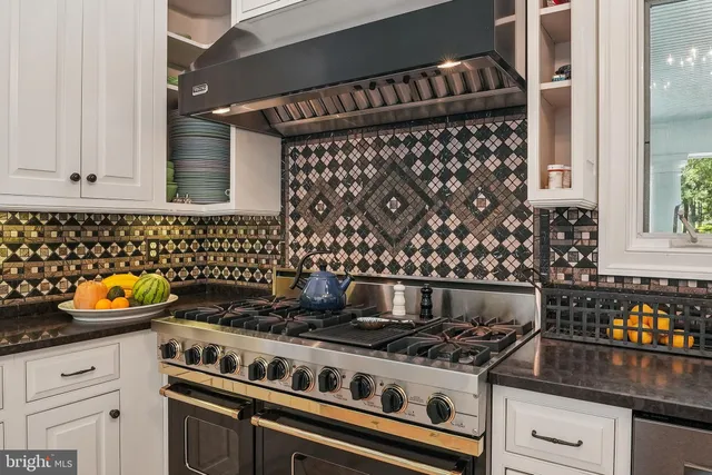 a kitchen with a stove and a white cabinets
