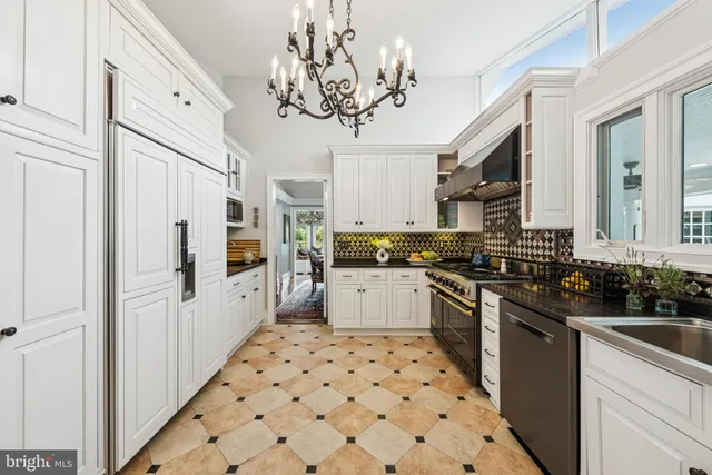 a kitchen with stainless steel appliances a refrigerator sink and cabinets