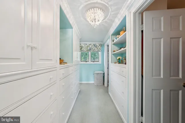 a spacious bedroom with a bed a couch and large window