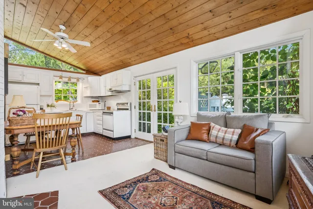 a view of a livingroom with furniture and a ceiling fan